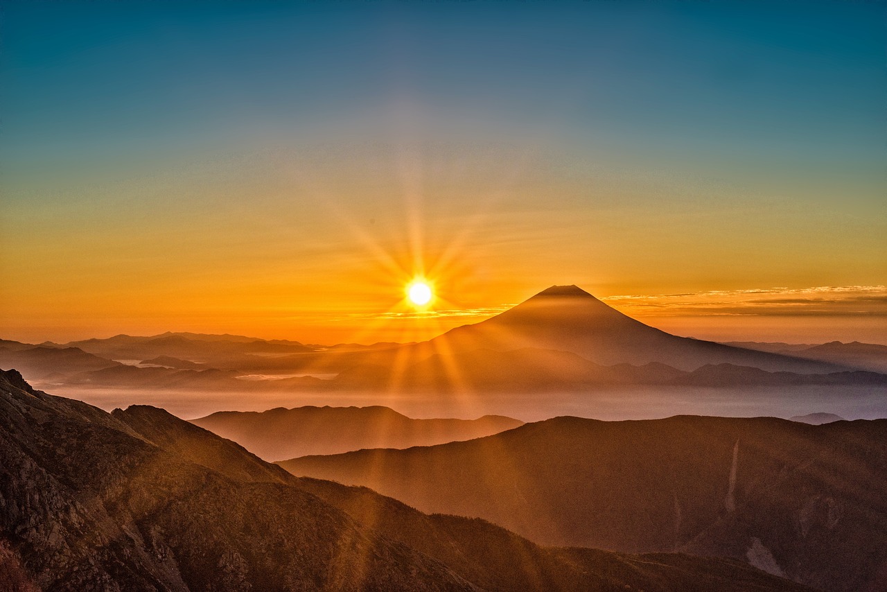 sunrise photo set against Mount Fuji. Misty morning in the mountains. Photo is by Image by Kanenori from Pixabay Link: https://pixabay.com/photos/mount-fuji-japan-volcano-mountain-2297961/